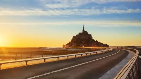 Estrada rumo ao Mont Saint Michel ao pôr-do-sol, Normandia. França.