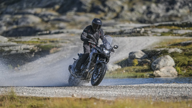 Honda CB500X a atravessar um curso de água.