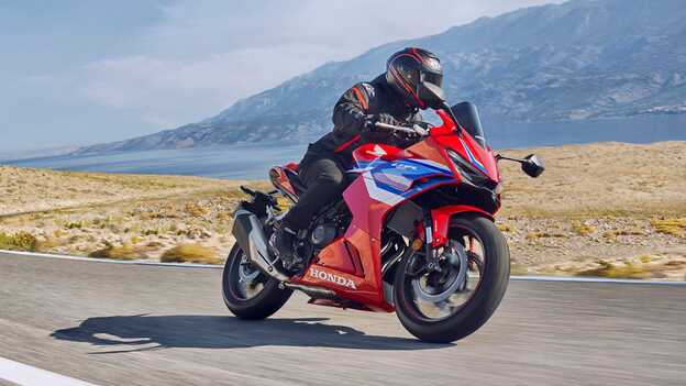 Fotografia dinâmica da CBR500R na estrada com condutor