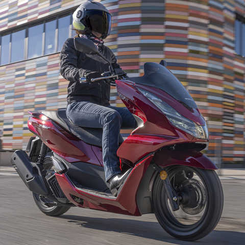 Honda PCX being ridden on street