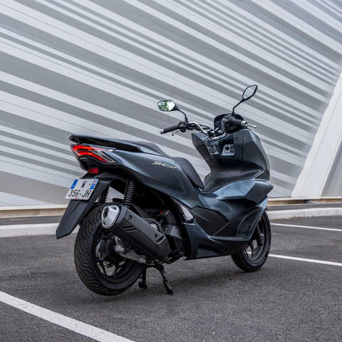 Honda PCX125 - vista a 3 quartos traseira direita, estacionada, moto cinzenta