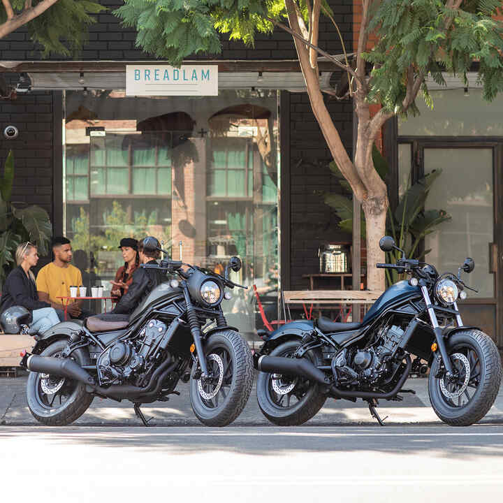 Vista lateral da CMX500 Rebel à frente de um café.